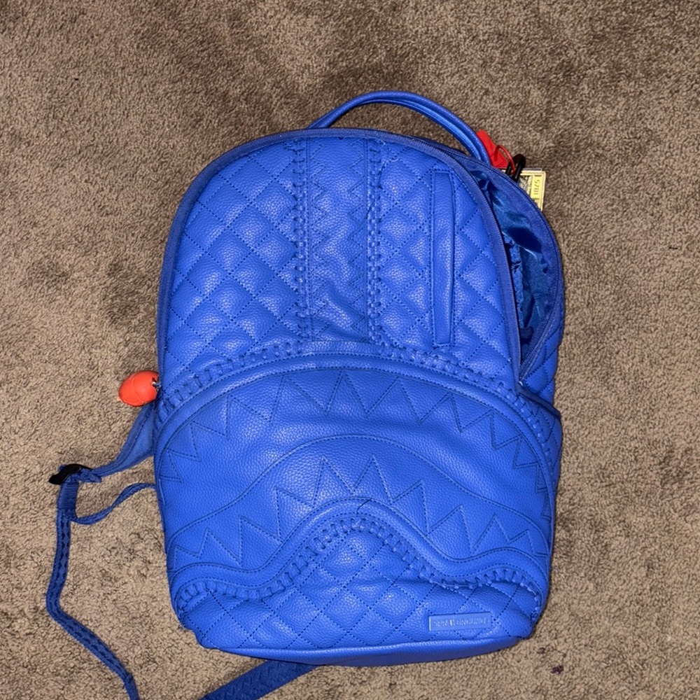 Sprayground Blue Backpack with Red Tag
